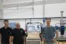 Alex Schaad and Markus Wyss (Beyond Gravity) with Marvin Tüscher (Kistler) in front of the proofload testing machine.